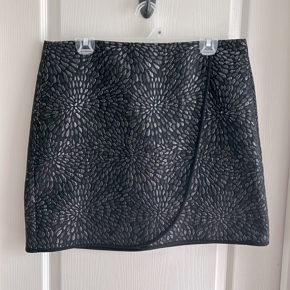 Black with metallic-like thread patterned faux-wrap skirt. Size 12.